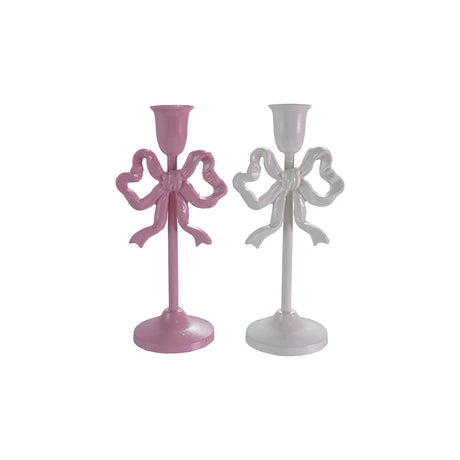 Two cast iron taper candle holders with bow design, pink and white