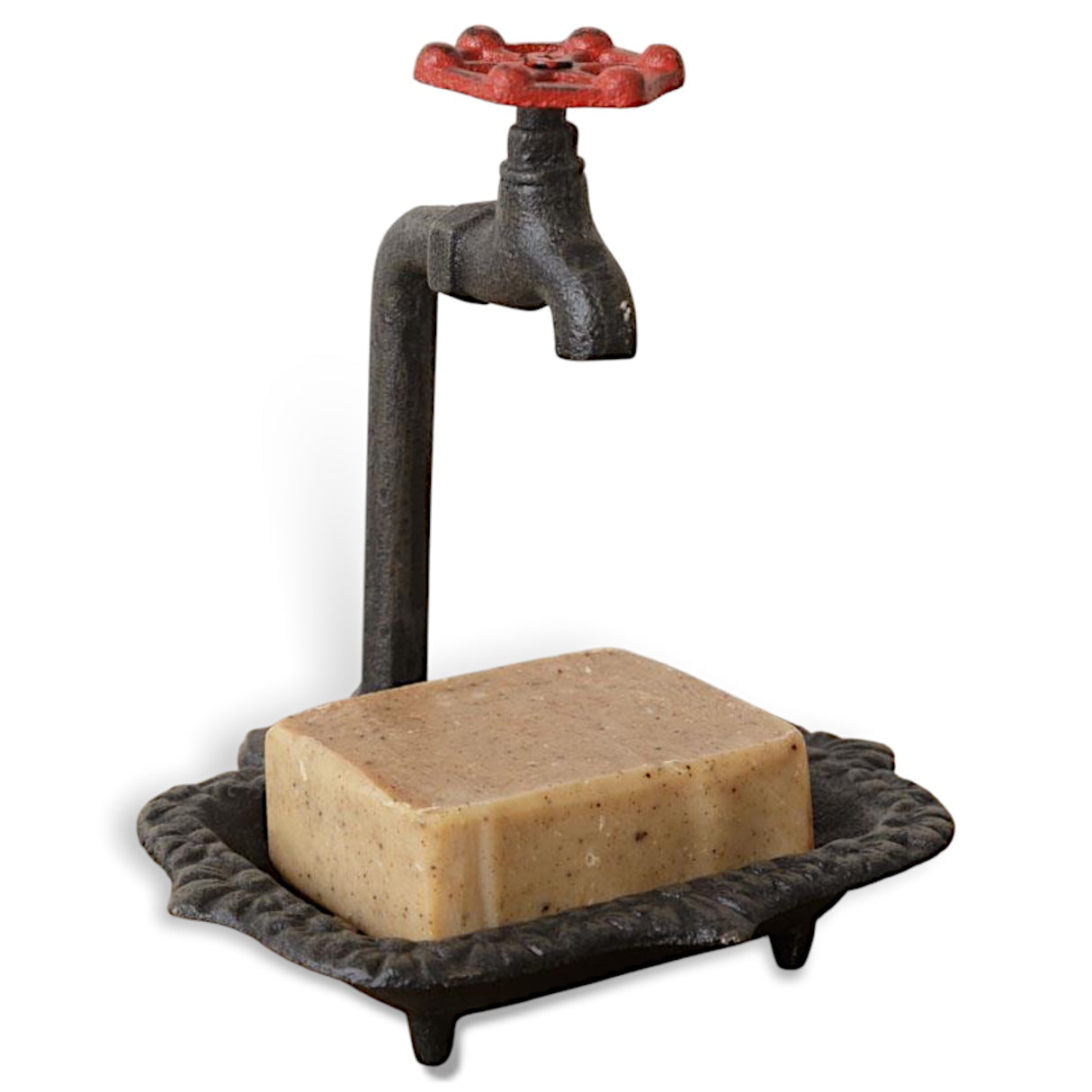 Vintage cast iron soap dish with decorative faucet handle, rustic finish