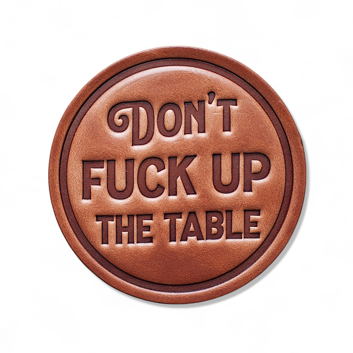Round leather coaster stamped with Don’t F*** Up the Table