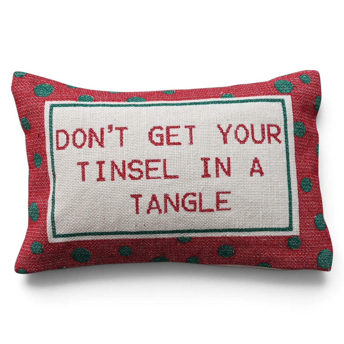 Cotton lumbar pillow with red embroidered “Don’t Get Your Tinsel in a Tangle” lettering and a red border with green polka dots.