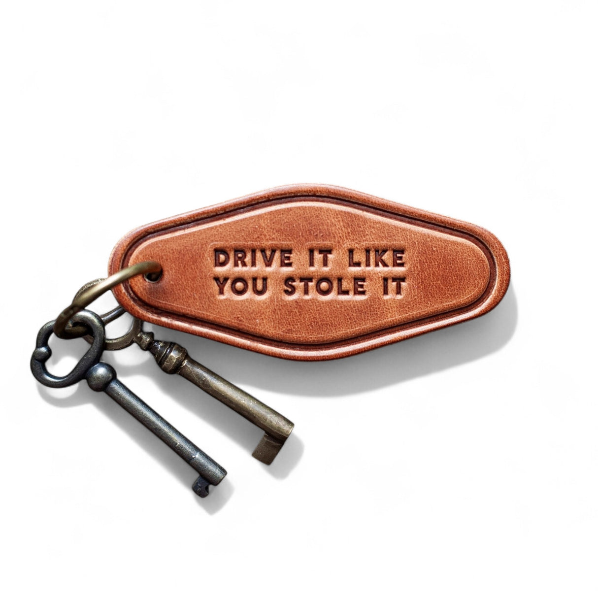 Brown leather motel-style keychain stamped with Drive It Like You Stole It