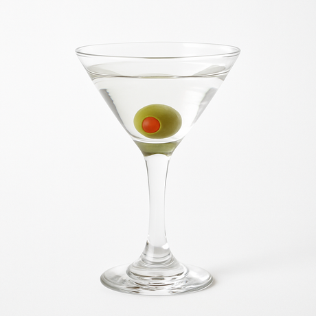 Realistic fake martini glass with olive garnish for display or decor use.