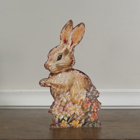 Cream-colored freestanding metal bunny with floral detail