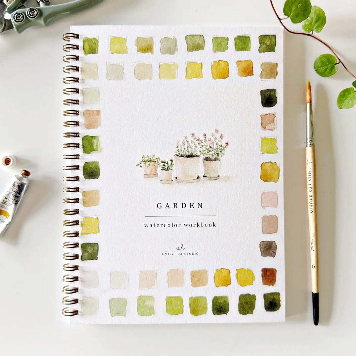 Garden watercolor workbook with 12 garden-themed illustrations and step-by-step painting instructions
