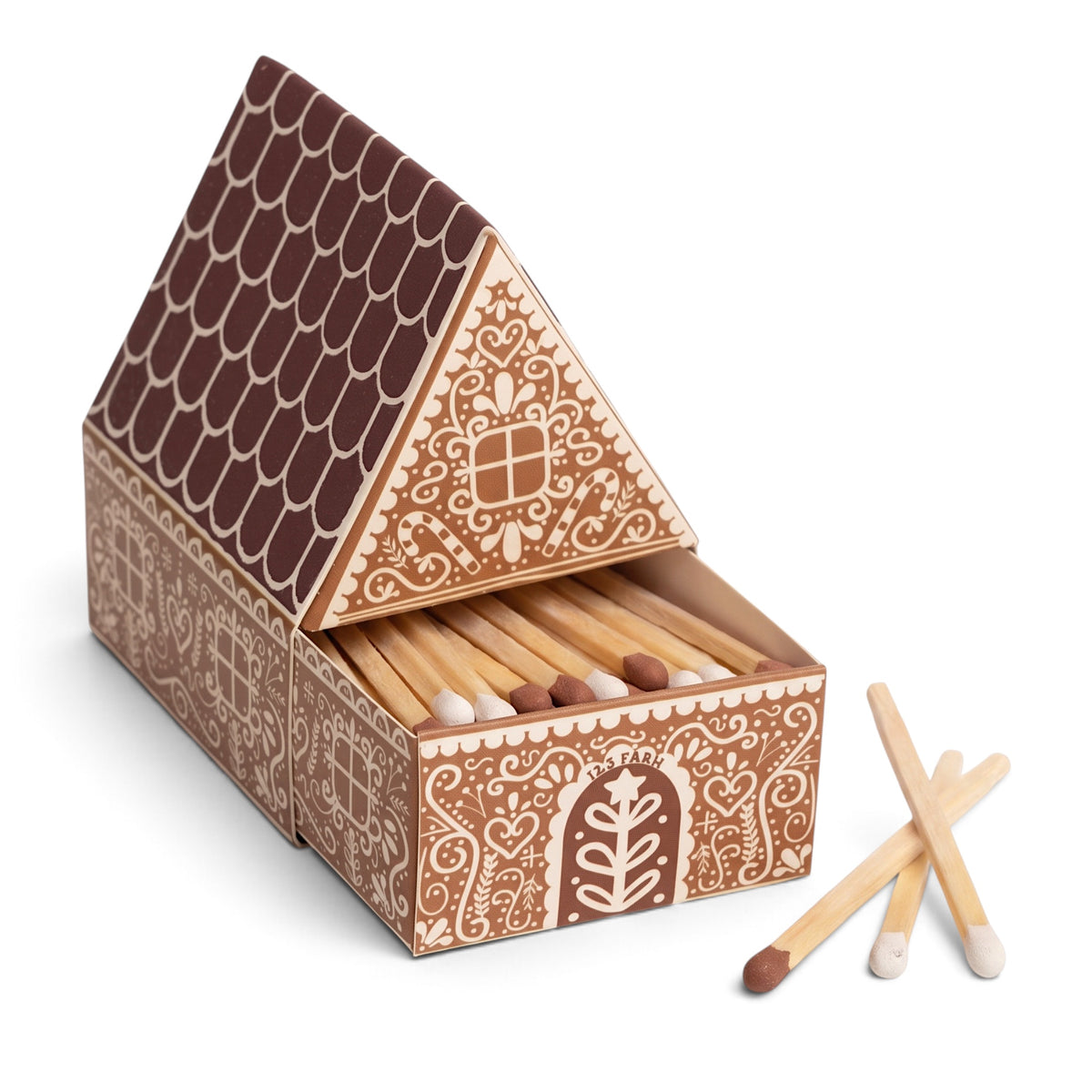 Gingerbread house matchbox with white icing-inspired patterns, a brown striker roof, and an open drawer of white- and brown-tipped matches