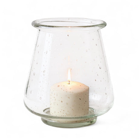 Clear speckled glass hurricane vase with candle inside
