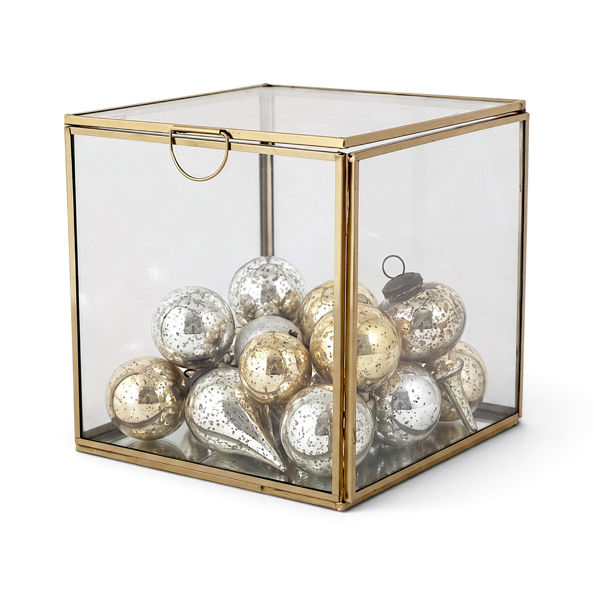 Small cube-shaped glass display box with a gold-tone metal frame and hinged glass lid
