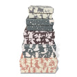 Stacked handmade holiday square gift boxes with festive recycled paper patterns