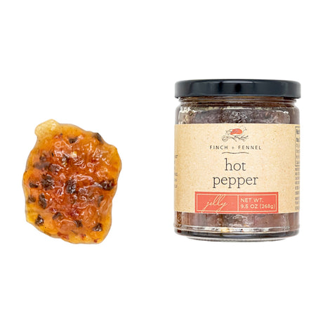 9.5 oz jar of hot pepper jelly with visible pepper flakes, perfect for crackers or cream cheese by Finch and Fennel