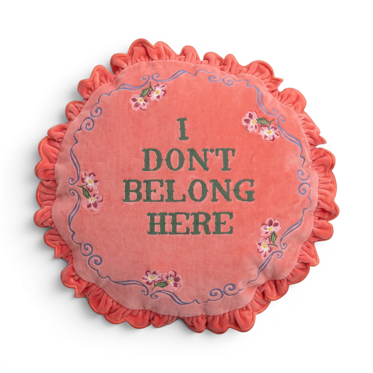 Coral pink I Don’t Belong Here round cotton velvet pillow with floral details and ruffled trim