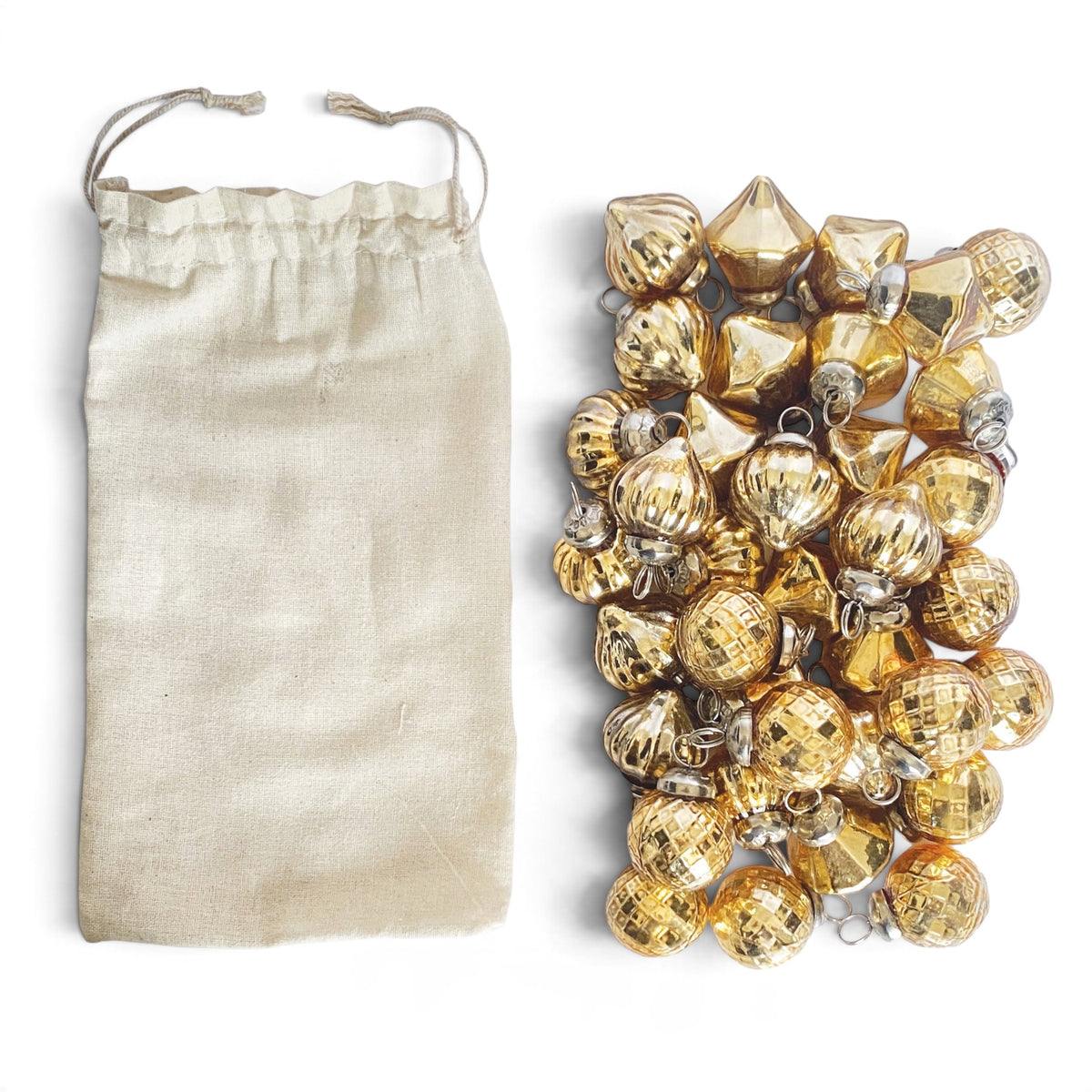 Assorted miniature gold mercury glass ornaments with embossed textures, metal hanging loops, and a natural muslin drawstring bag