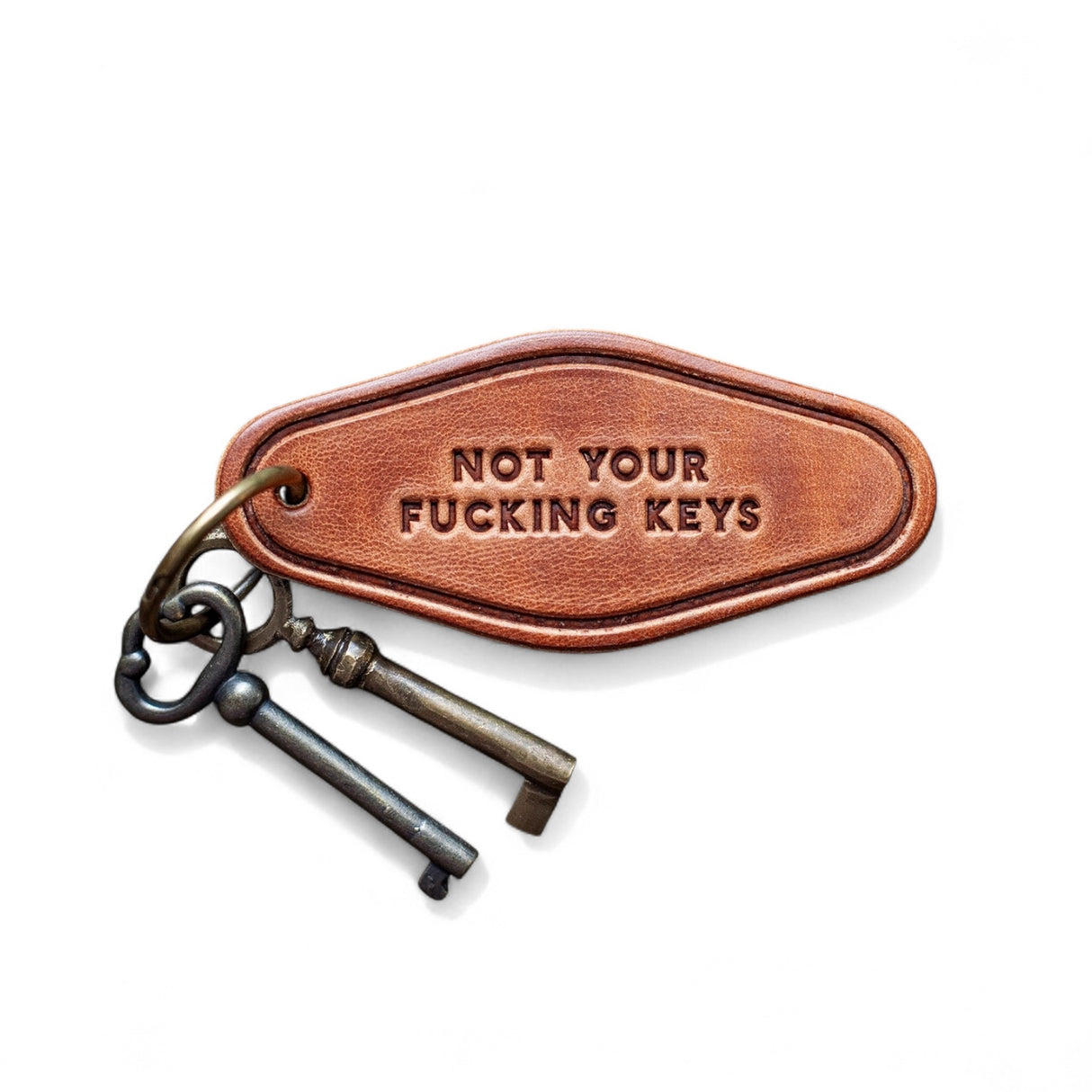 Brown leather motel-style keychain stamped with Not Your F***ing Keys and antique-style keys on ring