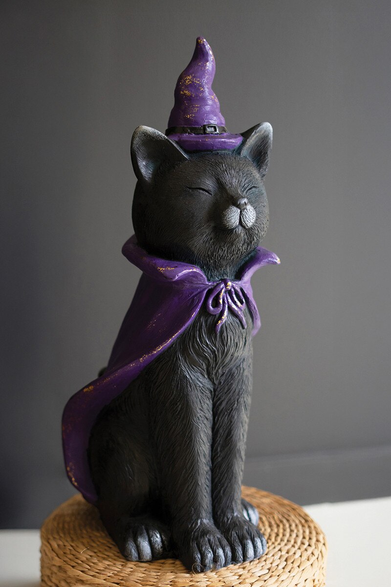 Painted resin black cat wearing a purple witch hat and cape