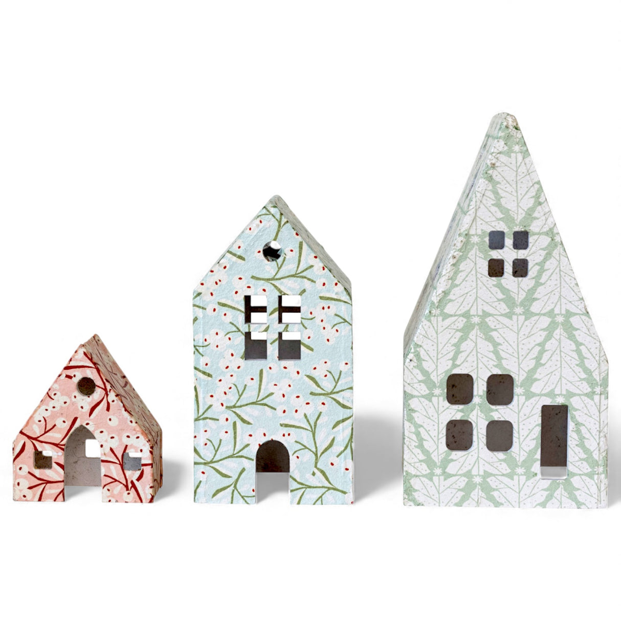 printed paper mache holiday houses with berry and tree patterns