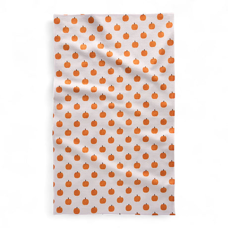 Tea towel with orange pumpkin pattern on a white background