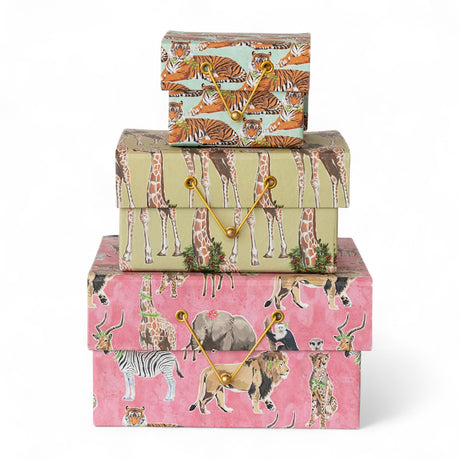 Stack of handmade recycled paper gift boxes with safari animal prints and gold cord closures