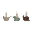 Set of three stoneware animal-shaped taper holders with reactive glaze, featuring bird, snail, and frog designs.