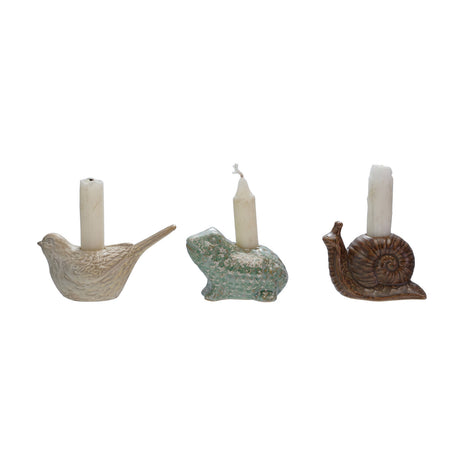 Set of three stoneware animal-shaped taper holders with reactive glaze, featuring bird, snail, and frog designs.