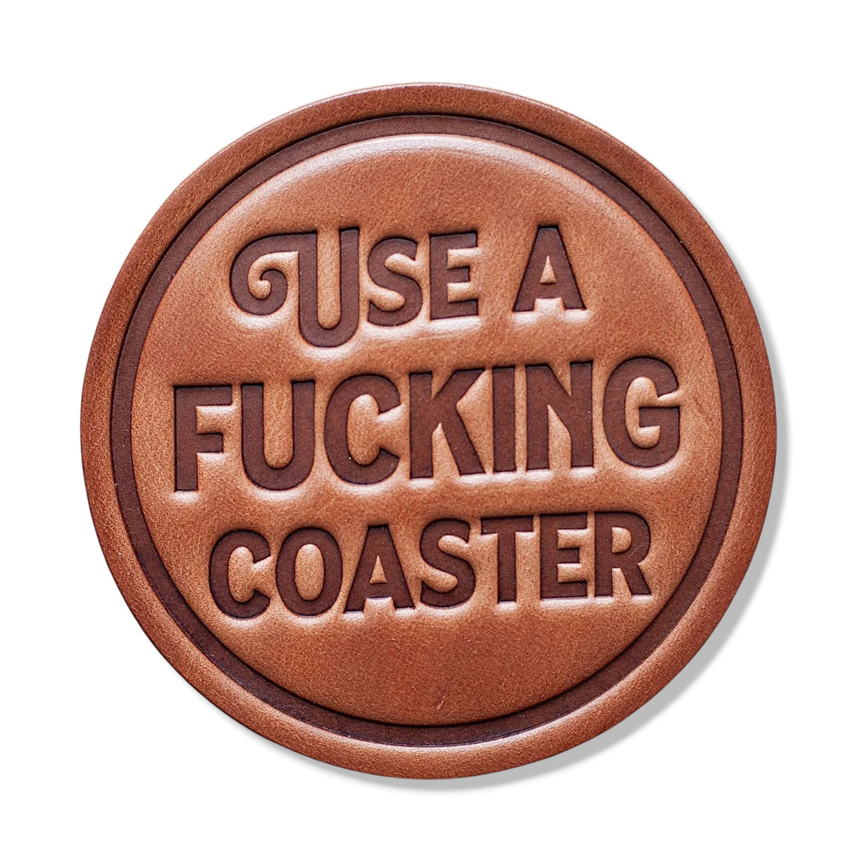 Round leather coaster stamped with use a fucking coaster
