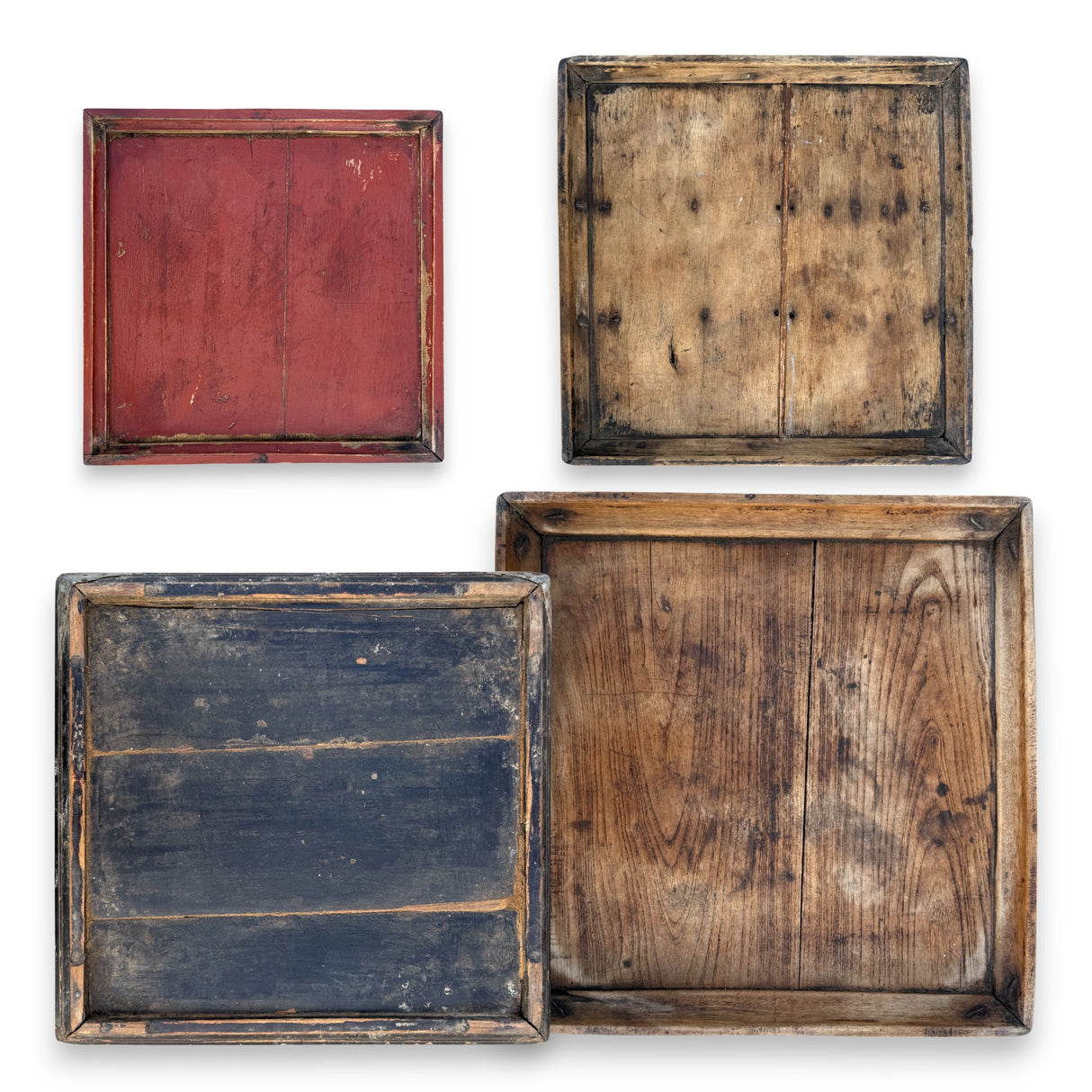 Assorted vintage hand-carved square wood trays with worn finish and natural grain