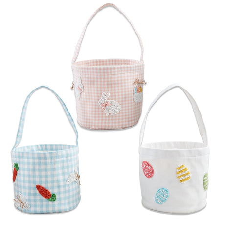 Woven cotton Easter baskets with beaded designs in three styles: pink gingham with bunnies, blue gingham with carrots, and white with eggs by Mud Pie