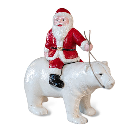 cast iron Santa riding polar bear figurine