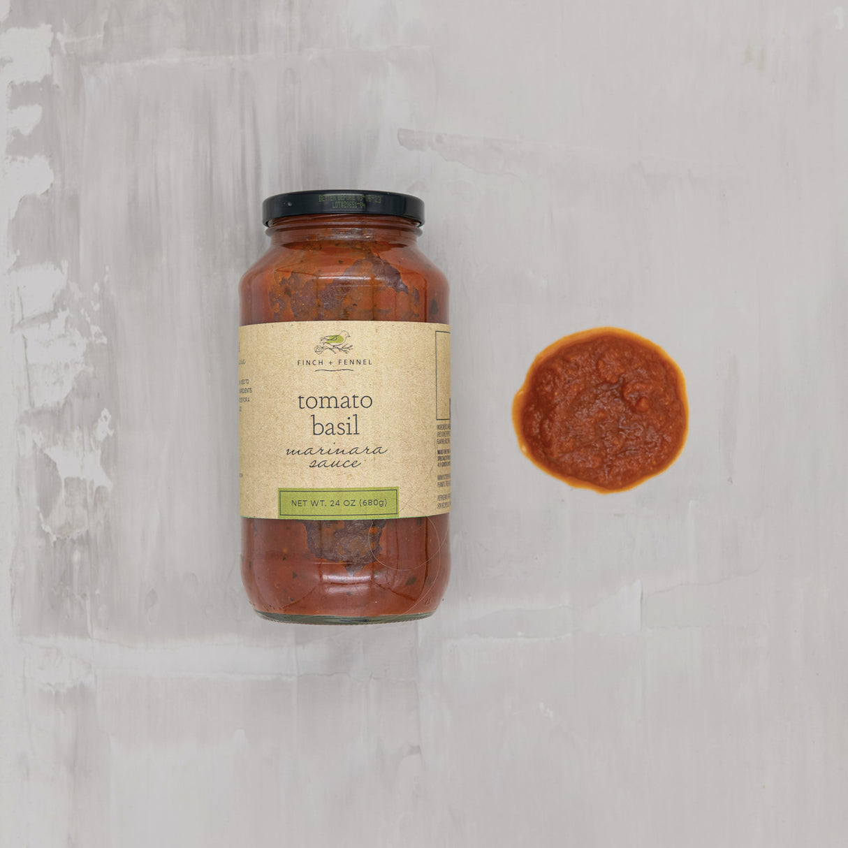 Finch + Fennel Tomato Basil Marinara Sauce jar shown beside a serving of sauce