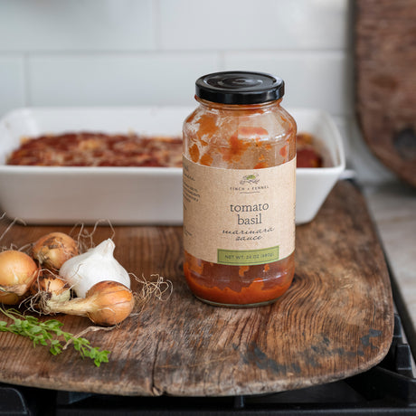 Finch + Fennel Tomato Basil Marinara Sauce jar with baked pasta, onions and garlic