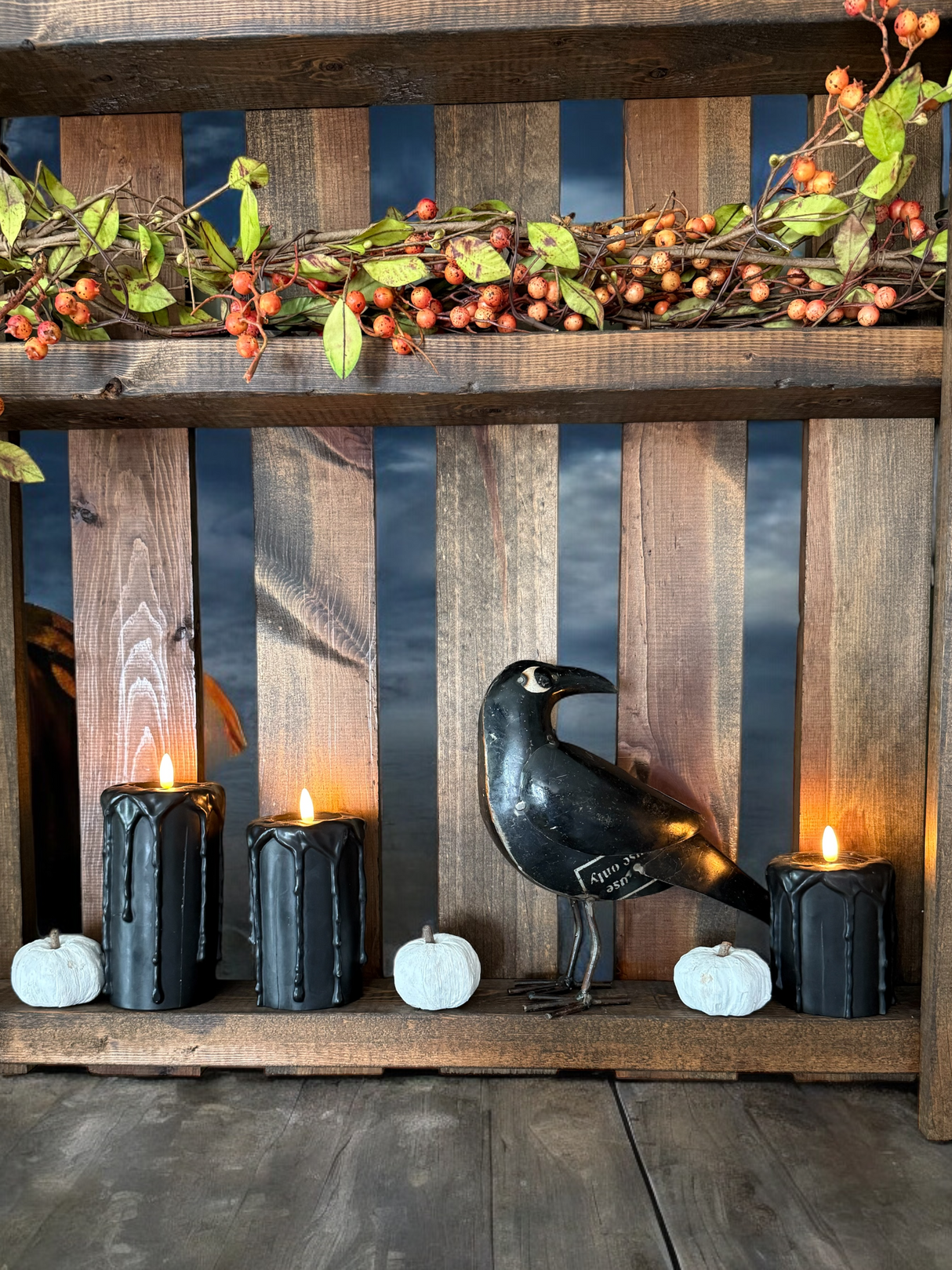 black metal crow displayed with halloween decor