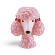 Pink ceramic poodle head vase with sculpted curly fur, floppy ears, red bows, and black eyes and nose