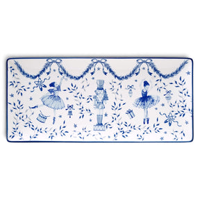Rectangular white ceramic tray with blue ballerinas, a central nutcracker, leafy garlands, bows, stars, and a thin blue border