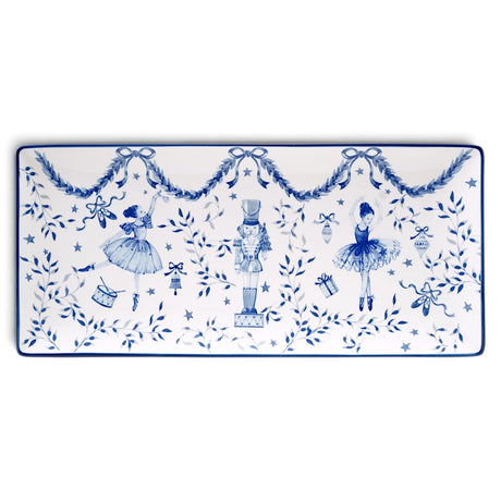 Rectangular white ceramic tray with blue ballerinas, a central nutcracker, leafy garlands, bows, stars, and a thin blue border