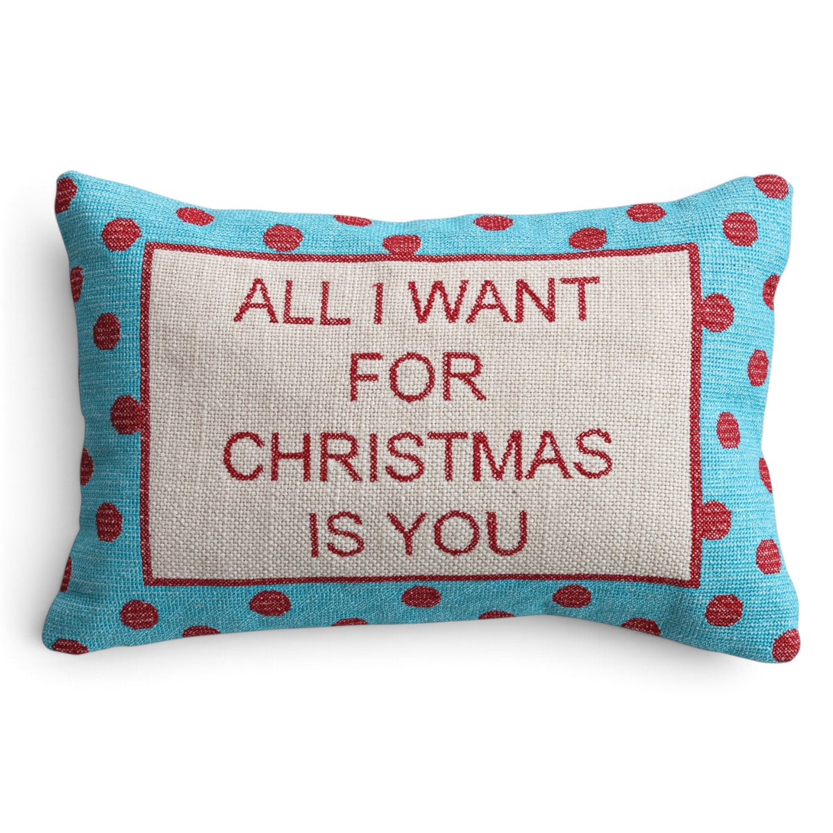 Cotton lumbar pillow with red embroidered “All I Want for Christmas Is You” lettering and a turquoise border with red polka dots.