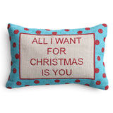 Cotton lumbar pillow with red embroidered “All I Want for Christmas Is You” lettering and a turquoise border with red polka dots.