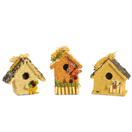 Set of three 6” decorative birdseed cottages with natural raffia, floral accents, and wooden birdhouse base.