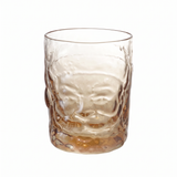 Amber-tinted drinking glass with a sculpted Santa face, hat, mustache, and beard beneath a round open rim