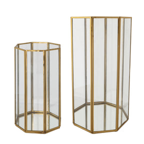 Two octagonal glass candle holders in different sizes with antique brass frames, open tops, and mirrored bottoms