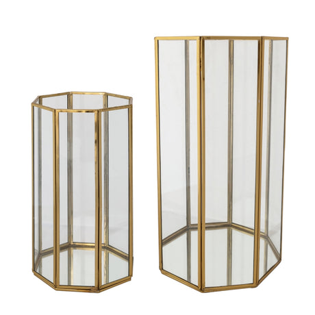 Two octagonal glass candle holders in different sizes with antique brass frames, open tops, and mirrored bottoms