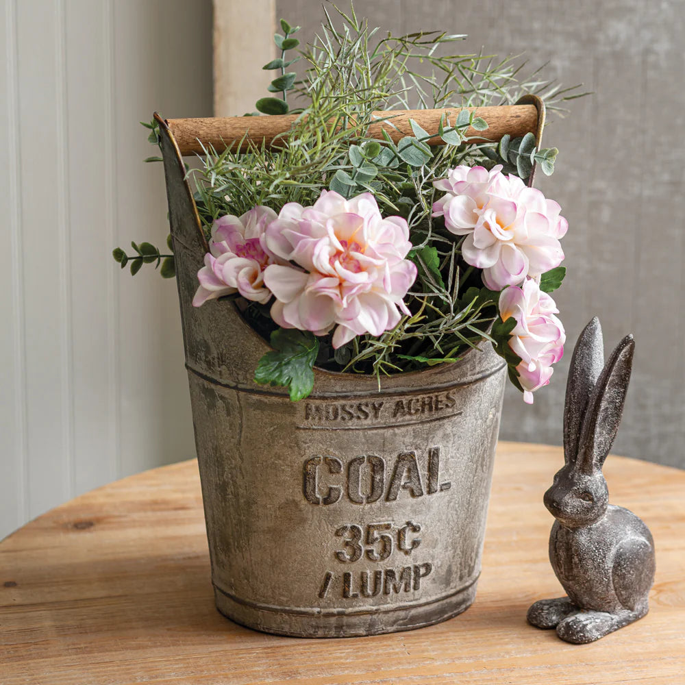 Antique-style metal coal bucket with embossed lettering and wooden handle