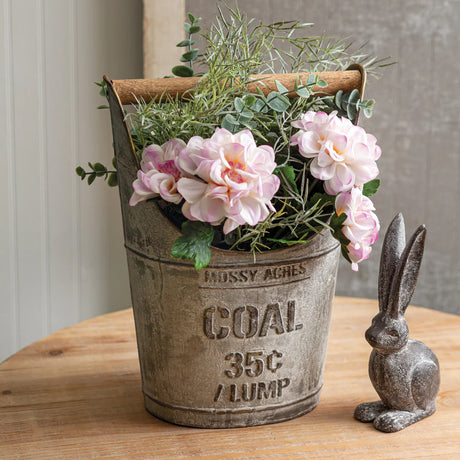 Antique-style metal coal bucket with embossed lettering and wooden handle