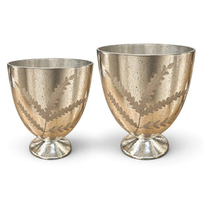 Etched mercury glass footed vases in two sizes with an antique silver finish, botanical branch patterns, and round pedestal bases