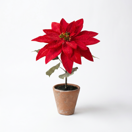 Artificial red poinsettia arrangement in a rustic cement pot for Christmas farmhouse holiday home décor.