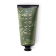 ILLUME Balsam & Cedar Demi Hand Cream in a green 3 fl oz tube with evergreen illustrations, gold lettering, and a black cap