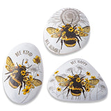 Resin decorative rocks with detailed bee illustrations and inspirational messages, each sold separately.