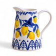Hand-painted stoneware pitcher with lemon design in blue, white, and yellow, 1.5 quart capacity.