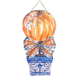 Blue and orange pumpkin fall door hanger with plaid bow and blue white planter made from recycled PVC