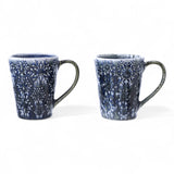 Blue stoneware mug with debossed snowflake pattern and reactive glaze