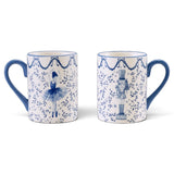 Opposite sides of a white ceramic mug showing blue ballerina and nutcracker illustrations with leafy branches, stars, bow garlands, and a blue handle