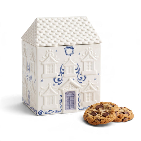 White and blue ceramic house-shaped cookie jar with stars, a wreath, and decorative detailing