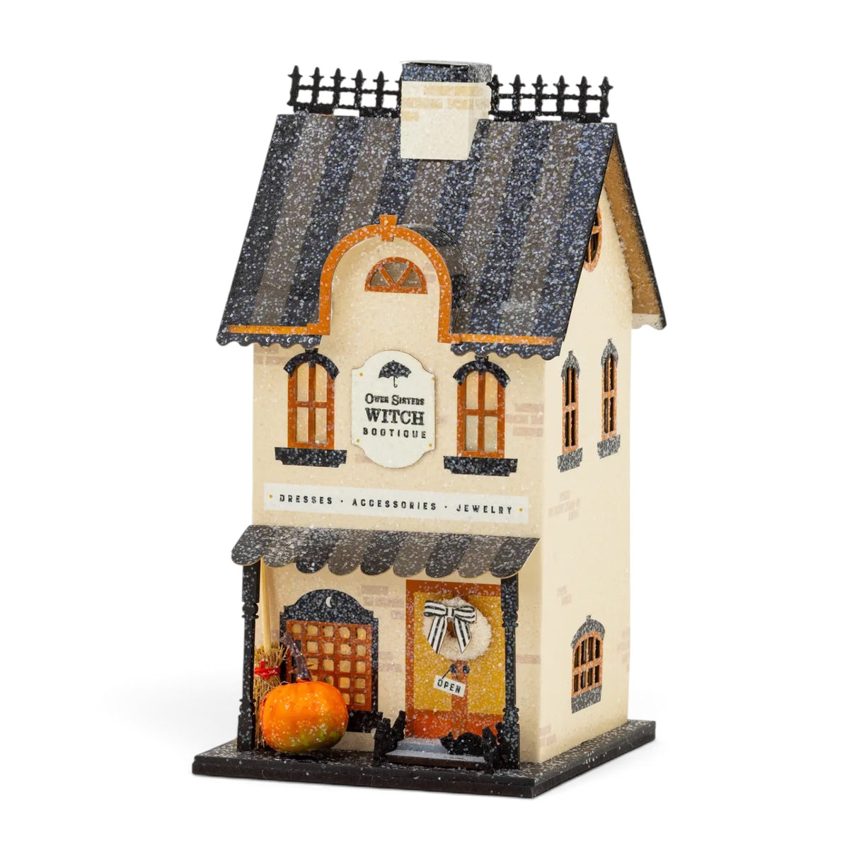 Lighted Halloween Witch Bootique paper village house with glitter accents, orange windows, pumpkin, broom, and 8-hour timer